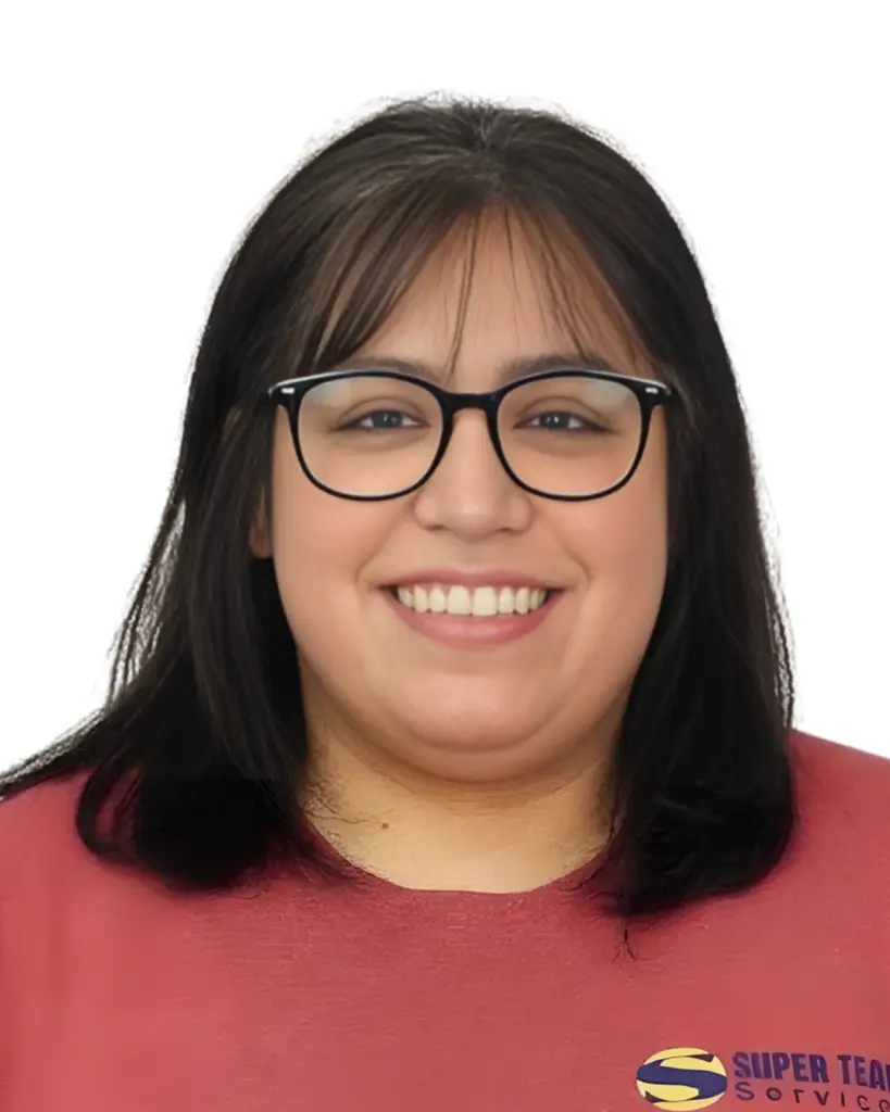 A woman with straight, shoulder-length dark hair and glasses smiles at the camera. She is wearing a red top. The background is white and her shirt has a partially visible logo on the lower right.